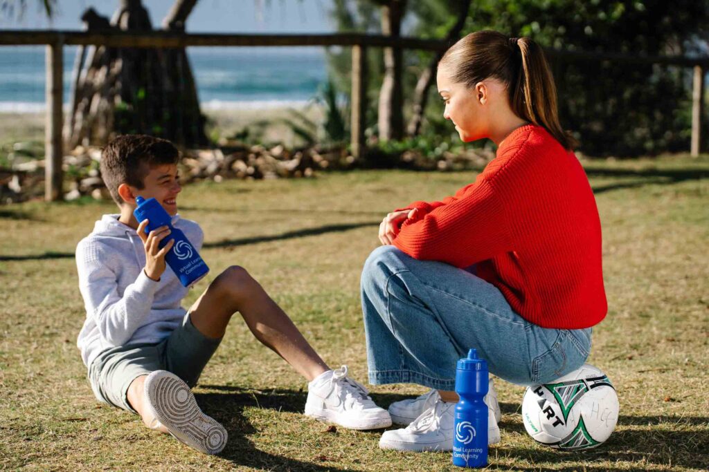 a boy and girl sit down talking to each other